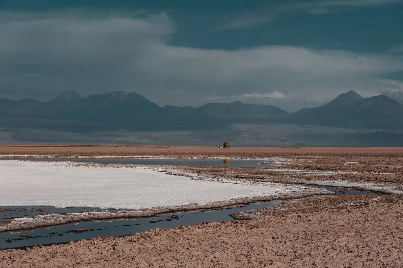 Salt crust polygons on the Salar de Atacama running to the Andes at first light