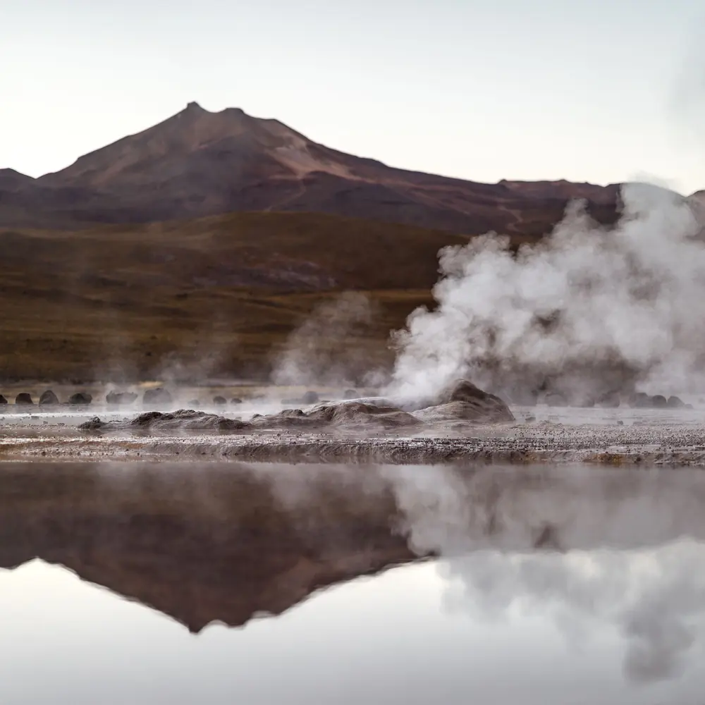 Steam columns rising at the El Tatio geyser field before sunrise