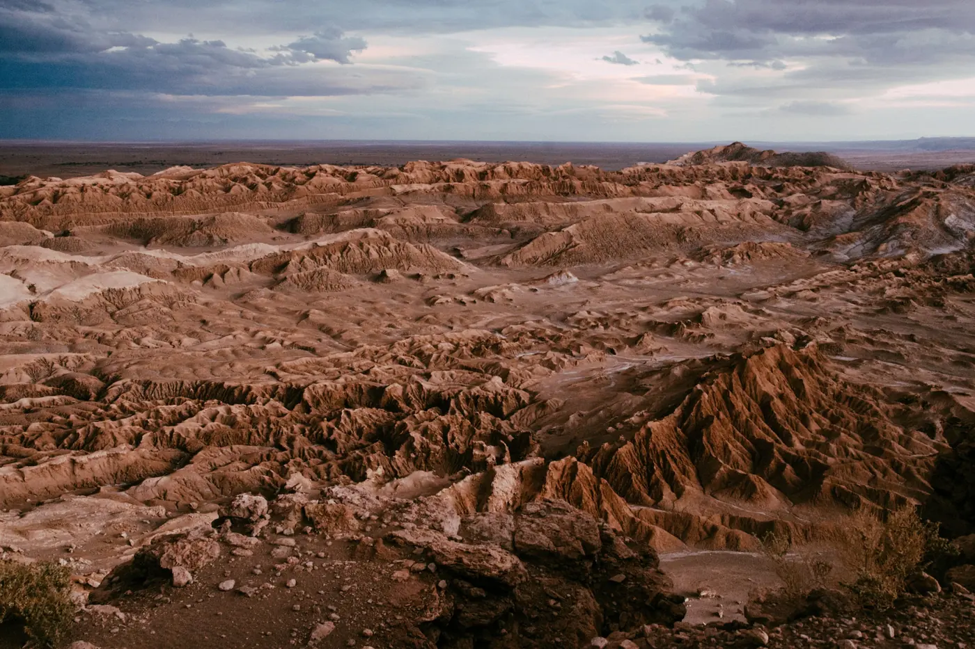 The salt ridges of the Cordillera de la Sal at sunset with Licancabur beyond